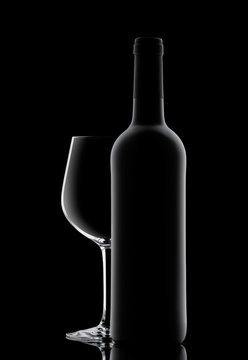 Silhouette of a bottle with wine on a black background