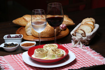 Italian dinner with breads, water and wine, table tidy