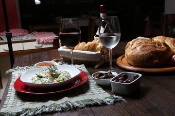 Italian dinner with breads, water and wine, table tidy