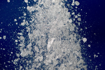 spray water from a fountain on a background of blue sky