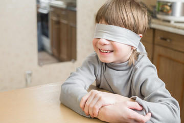 The child was blindfolded at home