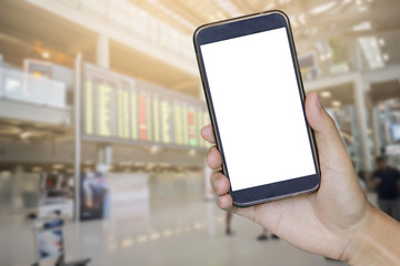 Man hand holding mobile smart phone , tablet,cellphone over blurred background of passenger at the airport, People walking in the airport with retro filter effect