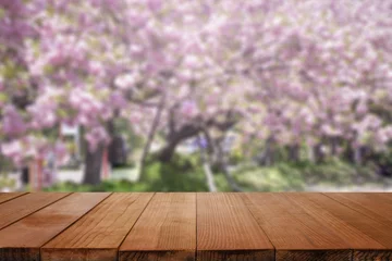 Papier Peint photo autocollant Mont Fuji Empty brown wooden table and blur background with Cherry blossoms. Spring landscape. Spring day.in spring time, sakura,for product display montage,can be used for montage or display your products.