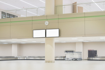 television on wall at International airport baggage claim area,