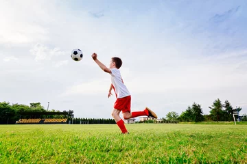 Foto auf Acrylglas 8 years old boy child playing football © Daniel Jędzura