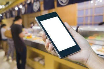 Women ’s Hand holding smart phone with food online device on screen over blur  japanese restaurant background, food online, food delivery concept.
