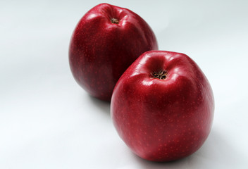 two red apples on a light background