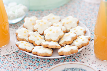 Mint-colored cake with handmade cookies and bottled juice