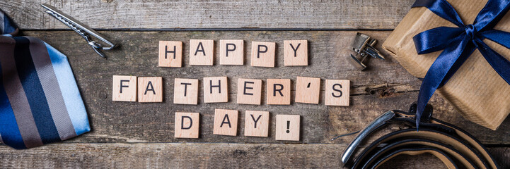 Father's day concept - present, tie on rustic wood background © anaumenko