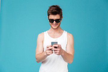 Happy man in sunglasses chatting by phone