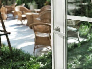 White glass window with modern handle open to garden. Concept of relax and take rest.