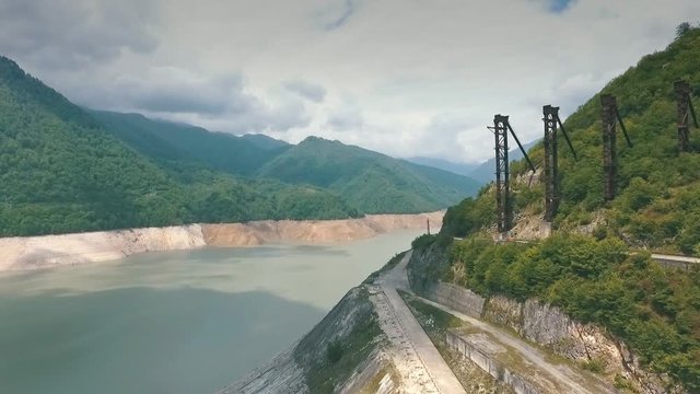 The Enguri hydroelectric power station HES. Inguri River next to Enguri Dam, surrounded by mountains