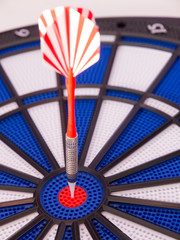 Dartboard with one red dart in center