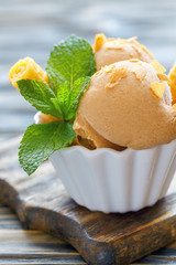 Balls caramel ice cream in a ceramic bowl.