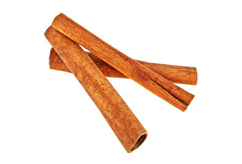 Three cinnamon sticks stacked on white a background