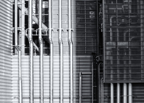 shiny steel pipes running down a metal industrial building