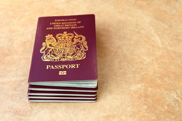 Stack of five British United Kingdom European Union Biometric passports with copyspace for text