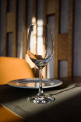 Empty glass arranged on a table in the restaurant, cafe, or bar. Preparation for the birthday, wedding, or any celebration day.