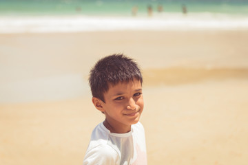 Kid boy ten years old by the beach enjoying the sunshine at Maracas Bay Trinidad and Tobago