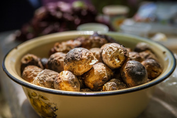 Baked potatoes in metal dishes.