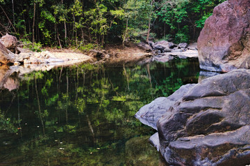Small mountain stream in the shade of the tropical forest, Mu Koh Chang National Park, Thailand. View from the trail to Khlong Phlu waterfall. Natural background.