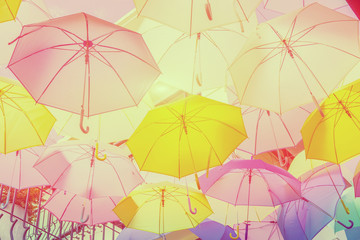 Fototapeta na wymiar Hanging colorful umbrellas backgroundon the street and blue sky