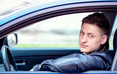 Portrait of a man in his car. Taxi driver concept. Happy automobile buyer. Test drive.