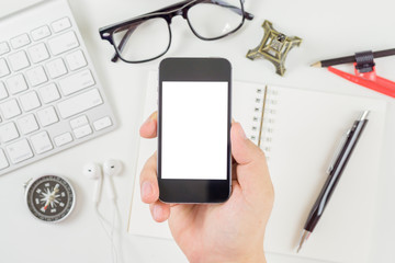 Businessman hands holding phone with isolated screen on the desk