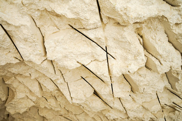 Grungy white cream limestone wall cave with scratches texture and light falloff from miner mining
