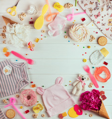 Baby shower party background with baby clothes, accessories and candies