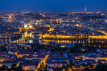 Prague at twilight blue hour, view of Charles Bridge on Vltava with Mala Strana and Old Town