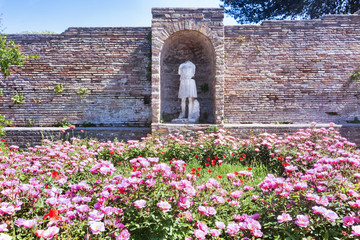 Glimpse of the Domus della Fortuna Annonaria courtyard ruins and Diana statue in the archaeological...