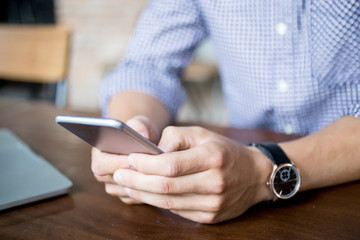 Obraz na płótnie Canvas Cropped View of Man Texting on Smartphone