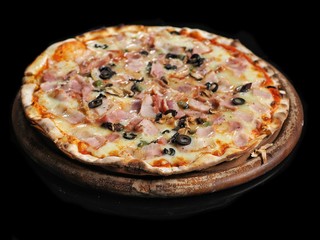 Hot supreme pizza on wooden board isolated on black background.