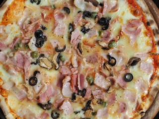 Hot supreme pizza, closeup.