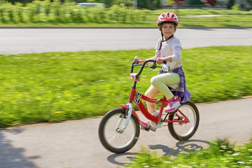 Girl learning to ride her bike