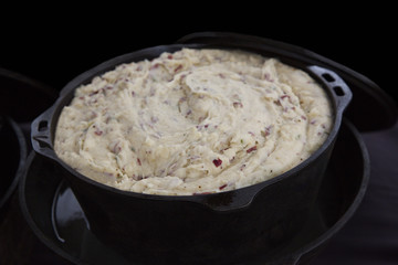 Cast iron pot filled with delicious, hot mashed potatoes