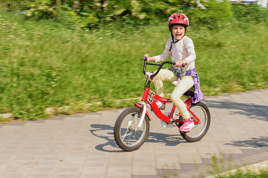 Girl learning to ride her bike