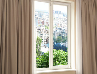 Cityscape view through modern window in room