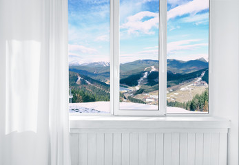 Fototapeta na wymiar Landscape view through modern window in room