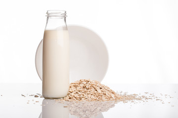 Flakes and milk on a white background