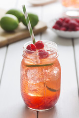 Fototapeta na wymiar Raspberry Lime Iced Tea or Cocktail on Table