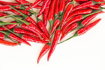red hot chili peppers, popular spices concept - beautiful handful of red hot pepper in bulk, pods scattered on white background, top view, flat lay, free space for your text