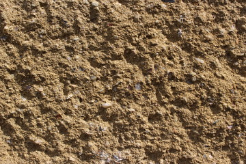 Decorative beige wall with small stones for background