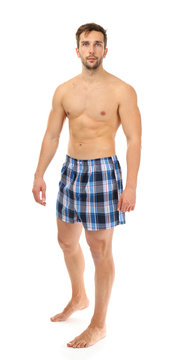 Man in blue boxers on white background
