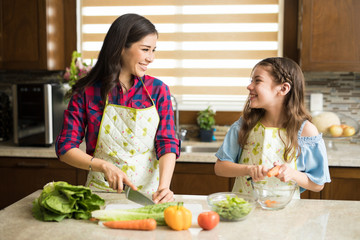 Mom and daughter making a salad