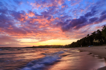 Fototapeta na wymiar Colorful sunset and waves
