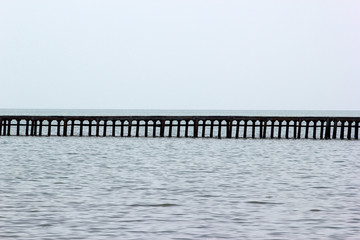 Long empty pier against sea horizon - abstract sea background