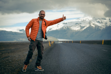 Fototapeta na wymiar Travel hitchhiker man on a road