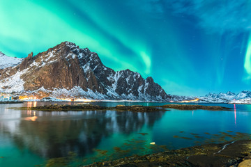 green northern light explosion over a fjord - obrazy, fototapety, plakaty